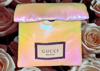 Gucci pink heart mirror wrapped in an iridescent protective pouch with the Gucci logo