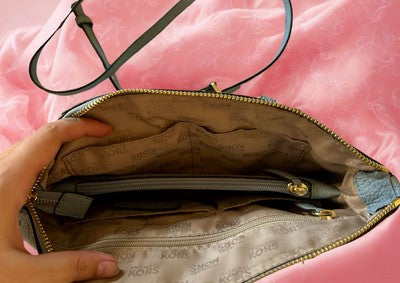 Inside view of a Michael Kors handbag bundle showing spacious compartments and elegant lining