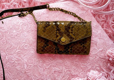 Michael Kors handbag bundle featuring a stylish snakeskin design with gold hardware clasp