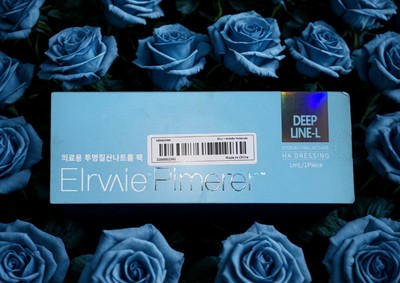 Elravie Deep Line-L filler packaging surrounded by blue roses for aesthetic appeal
