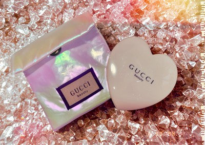 Set of patterned hair rollers in various colors, ideal for styling, featuring GUCCI beauty accessories